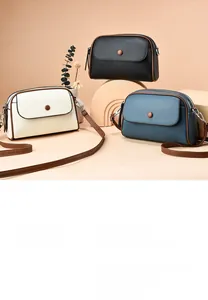 Detailed view of three mini textured crossbody bags in black, beige, and grey blue colors