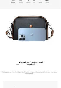 Detailed view of the mini black pebble leather crossbody bag next to a smartphone