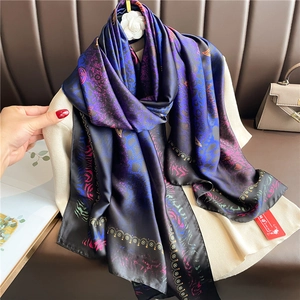 Macro detail of luxury leopard print satin scarf featuring vibrant blue and purple gradients