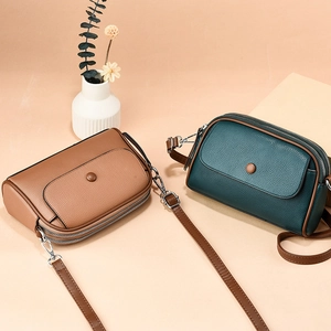 Brown and green minimalist pebbled leather crossbody bags with adjustable straps