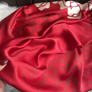 Luxury red silk shawl with vintage floral patterns on a plush background for women