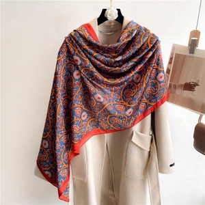 Royal blue floral silk shawl with golden chain patterns over a minimalist beige coat