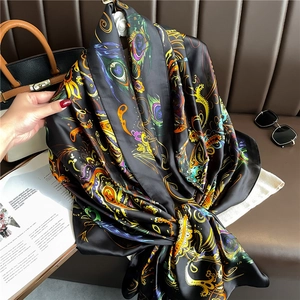 Luxurious large black silk scarf featuring colorful peacock feathers and paisley patterns