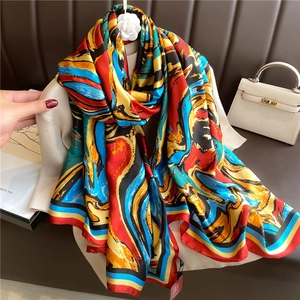 Detailed macro of large silk scarf featuring artistic abstract oil painting print and hem