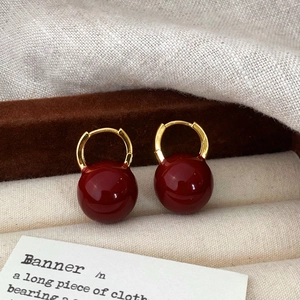 Retro red resin bead hoop earrings displayed in a beige velvet jewelry box