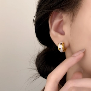 French retro leopard print enamel hoop earrings in gold finish on female model