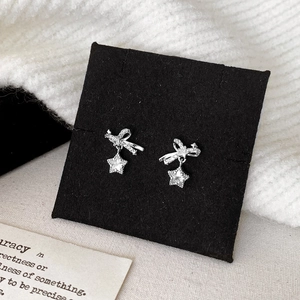 Elegant silver bow and star pendant earrings with pavé zircons for a minimalist chic look
