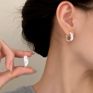 Elegant irregular pleated earrings with matte silver finish and a minimalist C-shape design