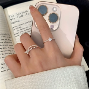Minimalist silver ring set featuring a classic zircon solitaire and a pearl butterfly band