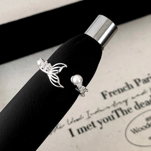 Elegant silver fishtail open ring featuring pearl and zircon accents on black stand