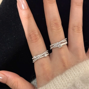 Elegant silver layered crisscross rings with micro-pave cubic zirconia on female hand