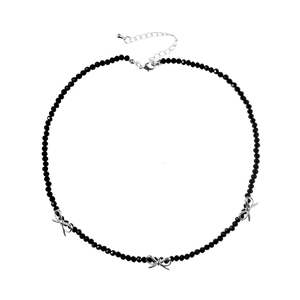 Minimalist beaded necklace featuring black faceted beads and three silver bow pendants