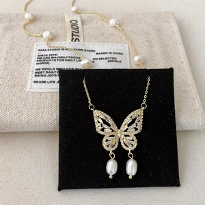 French luxury gold butterfly necklace with freshwater pearls and zircon details
