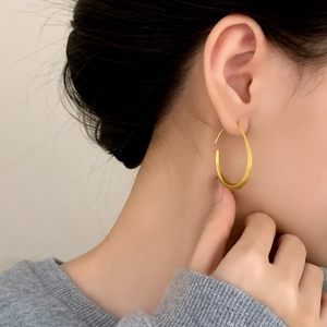 Elegant matte gold teardrop hoop earrings featuring a minimalist brushed metal design