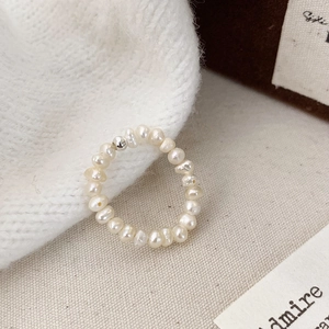French minimalist beaded ring featuring natural freshwater pearls and a silver accent bead