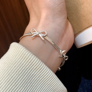 Minimalist silver butterfly snake chain bracelet with elegant metallic bow accents