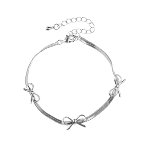 Elegant silver snake chain bracelet featuring three stylish bow charms and adjustable clasp