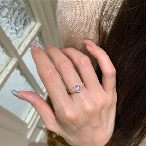Macro view of flower ring in rose gold with pink gemstone and zircon pavé detail
