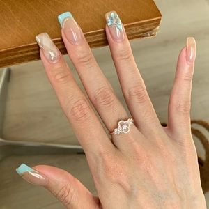 Rose gold adjustable clover ring with pink mother of pearl and zircon pavé on model