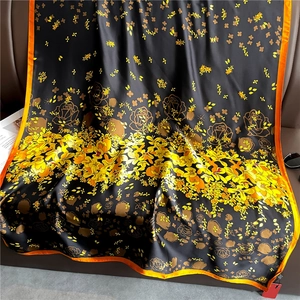 Luxurious long silk-feel shawl with elegant floral prints and bright orange rolled edges