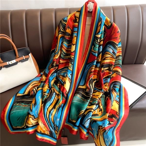 Detail of large luxury silk scarf with vivid abstract marble patterns and striped borders