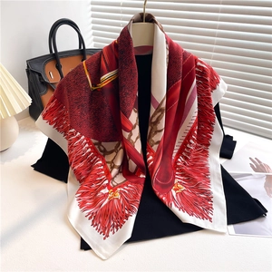 Detail of elegant color-block silk scarf with intricate tassel patterns and rope textures