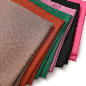 Detail showing various colors and pleated texture of chiffon scarves with silver glitter