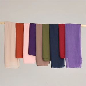 Hanging display of solid color chiffon scarves showing multiple vibrant shades and texture