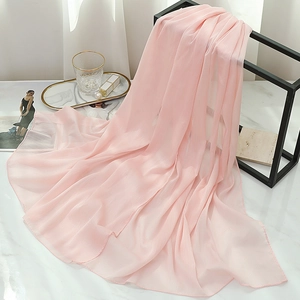 Detail of light pink pleated chiffon scarf with subtle shimmer and soft texture