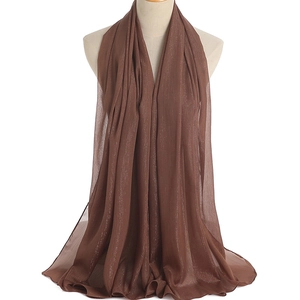 Detailed macro of coffee brown chiffon scarf with metallic glitter and fine stitching