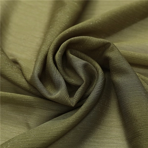 Detailed macro shot of dark olive green chiffon scarf with subtle silver shimmer and texture