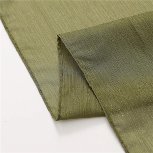 Macro shot of olive green chiffon scarf featuring metallic silver thread and pleated texture