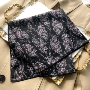 Elegant paisley satin square scarf in black and white on a classic trench coat background