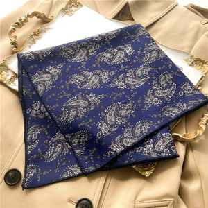 Detail of navy blue paisley satin scarf showing smooth texture and fine edge stitching