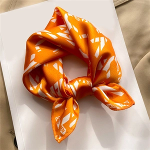 Elegant orange silk-like scarf with minimalist white geometric letters and numbers print