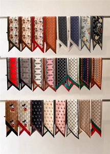 Detailed display of colorful patterned silk twilly scarves hanging on a rack