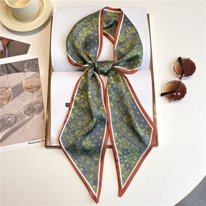 Polka dot skinny silk scarf with paisley pattern and orange edge on fashion magazine