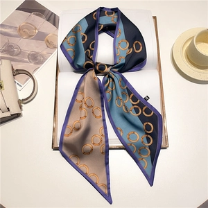 Close-up of lightweight polka dot skinny scarf with orange ring patterns and purple trim