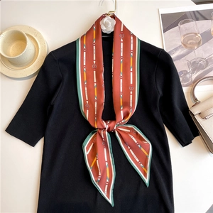 Close-up of narrow polka dot neck scarf tied on a chic black knit top for styling
