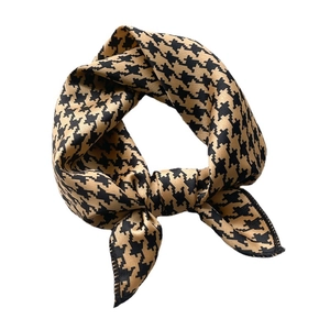 Elegant black and yellow houndstooth silk-satin square scarf shown with a stylish knot