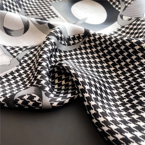Macro shot of houndstooth silk scarf showing smooth texture and geometric patterns