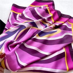 Macro shot of abstract purple wave pattern silk scarf with smooth glossy texture