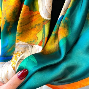 Elegant lotus print silk scarf with emerald green tones and classic satin finish