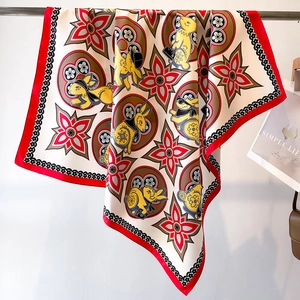 Detail of silk square scarf featuring rabbit print and premium red border texture