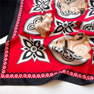 Detail of red square silk scarf featuring Chinese zodiac rabbit print and wavy borders