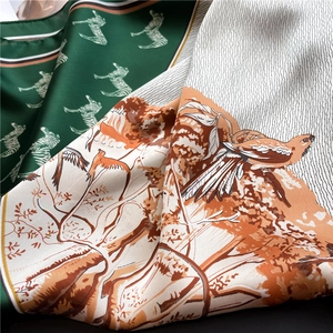 Detailed view of the double-sided silk scarf featuring zebra print and vintage nature patterns