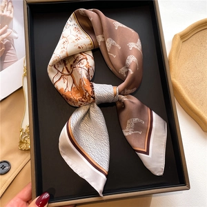Detail of silk scarf with zebra print and botanical patterns on a display tray