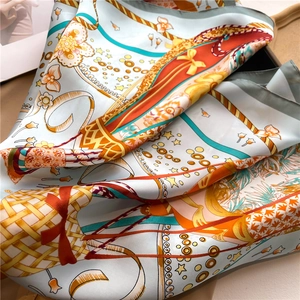 Detailed macro view of colorful hot air balloon silk scarf with intricate floral patterns