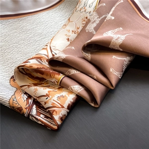 Detail of silk satin scarf showing zebra print and luxurious draped fabric texture