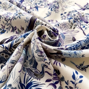 Detail of floral bird print scarf showing elegant herringbone weave texture